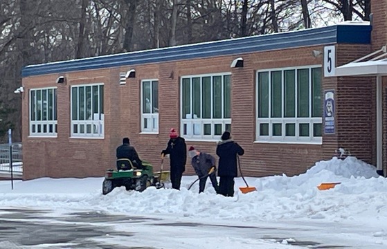 custodians shoveling snow