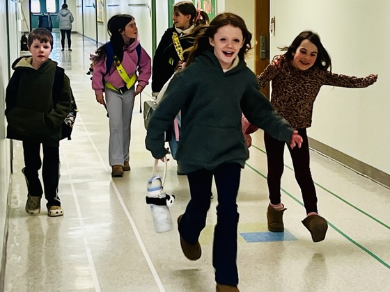Kids coming down the hall ready for class 