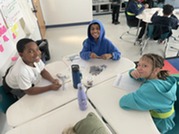 A group of students working on an electrical circuit lab. 