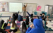 Students discussing lab with teacher. 