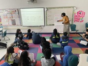 Student discuss lab with teacher. 