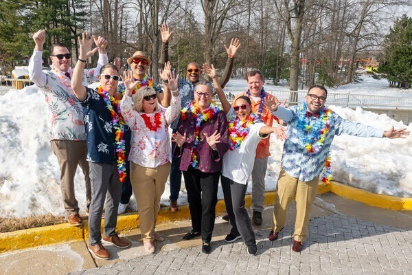 picture of adults outside in the snow wearing summer floral shirts