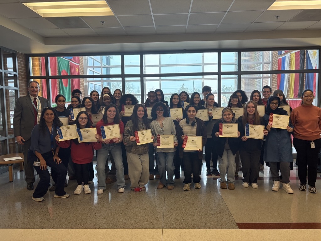 Group of students and staff standing with their science fair awards