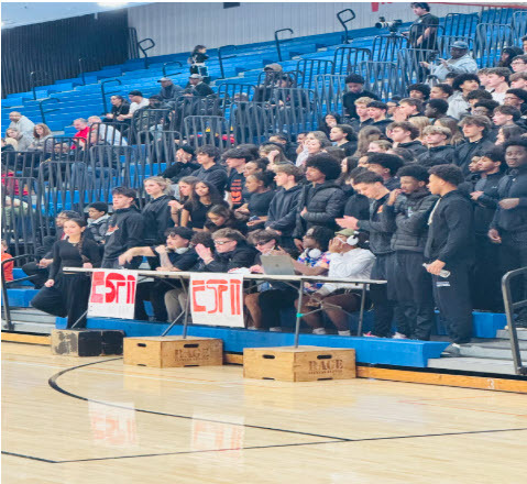 students in stands at basketball game