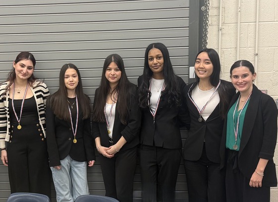 students dressed professionally with their medals after competition