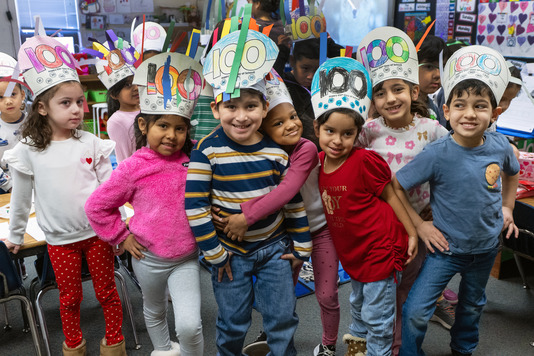 100th day of school students smiling and hugging