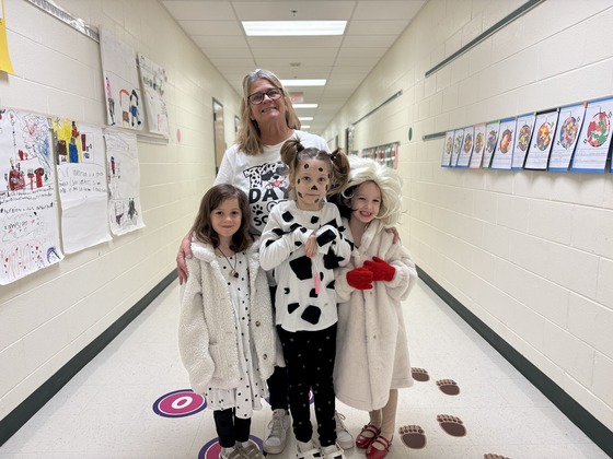 A teacher and three students dressed as Dalmatians and Cruella de Vil for the 101st Day of School celebration