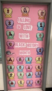 Classroom door decorated with hearts and historical African Americans stating "Falling in Love with Black History Month"