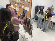 Sixth Grade students filming the news show. 
