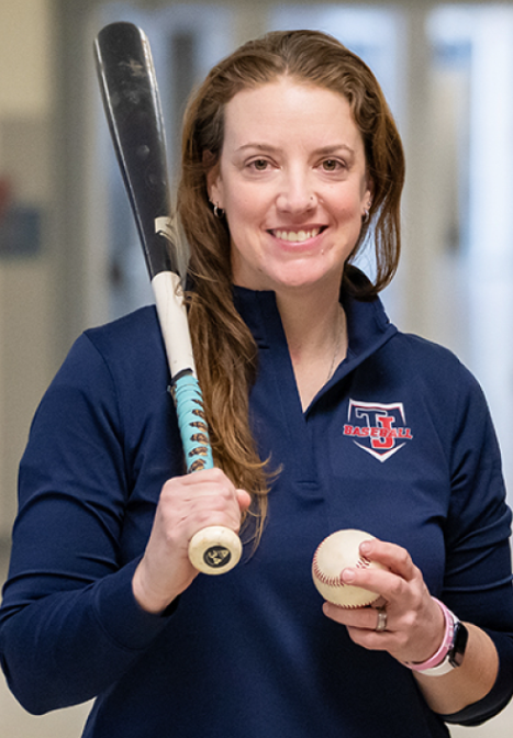 Woman holding baseball and bat
