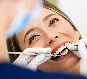 Dental Assistant cleaning a patient's teeth