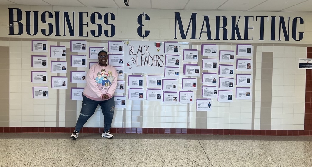 teacher standing in front of black leaders honor black history month