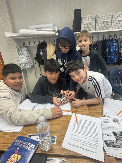 Boys gather around science project