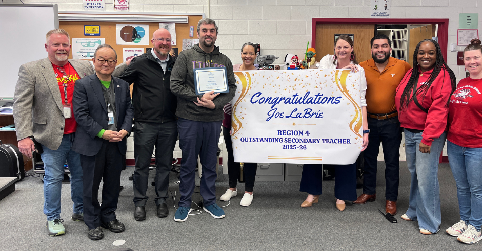 Several teachers and school administrators gather to congratulate Joe LaBrie for being selected as the Region 4 Outstanding Secondary Teacher.  