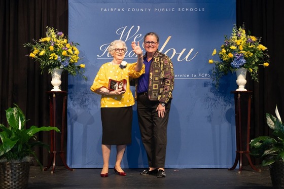 Dr. Reid presents a retirement award to an employee