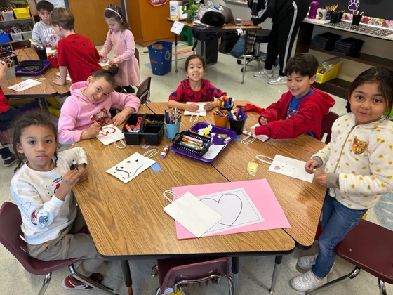 Students making valentine bags and hearts