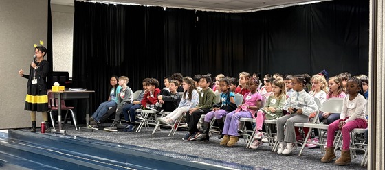 Student spellers waiting on the stage to begin the spelling bee