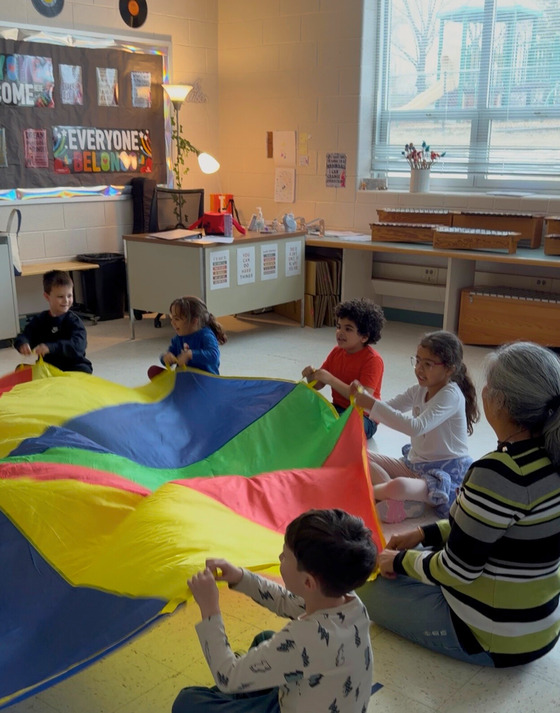 Students using parachute in music class