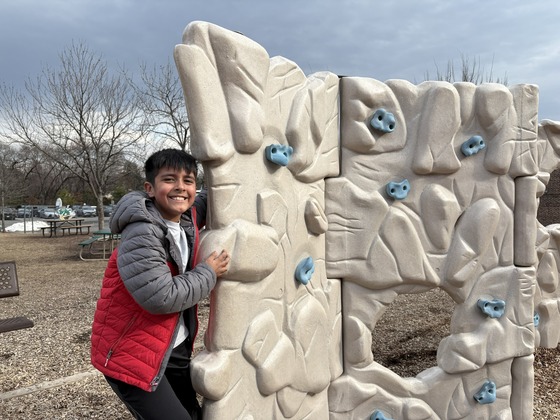 Student climbing rock wall at recess