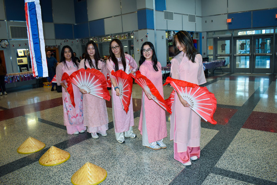 Four TJ Students doing a traditional dance with fans.