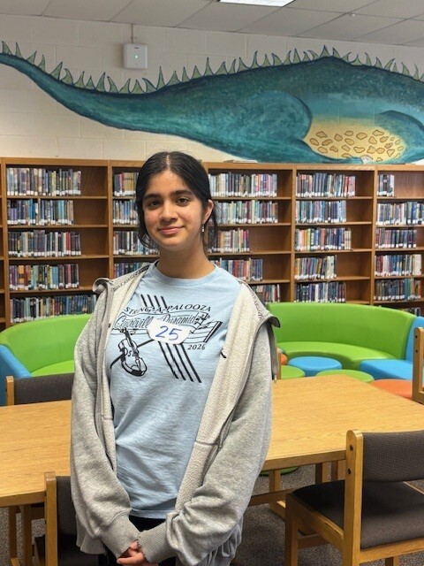 a girl standing in front of a table