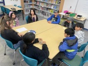 A group of students meet with Mrs. Winer for student council. 