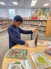 Student looking at books in the library