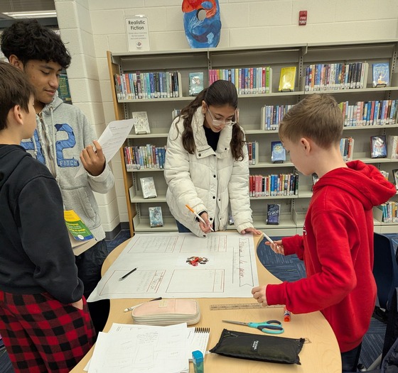 Spanish students working on a project in the library