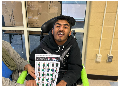 Celebrating Black History with Bingo Fun!- student holding a bingo sheet