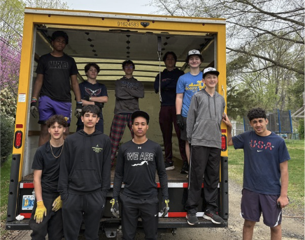 students standing in a box truck
