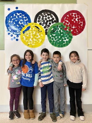 Students standing in front of Olympic Rings