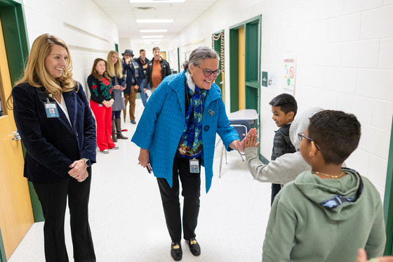 Dr. Reid high-fives student