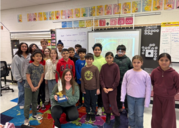Group of children standing together holding a trophy