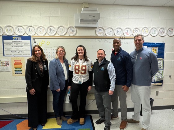 Photo showing Ms. Travis with flowers after receiving Outstanding staff nomination for Region 5