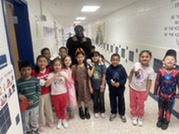 Mrs. Isley and her first graders dressed up for superhero day.