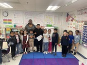 Here are first graders with a sixth grade mystery reader.