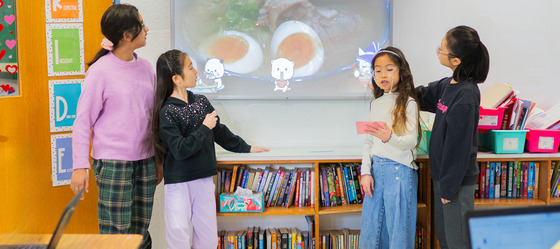 Kent Garden Students giving a TED talk presentation in front of white board in classroom