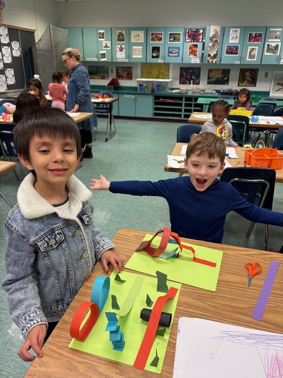 Kindergarteners in art class making paper playgrounds