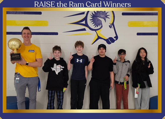 Raise the Ram card winners posing with Mr. Kownacki with a basketball trophy
