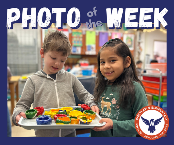 Photo of the week: two children hold a tray with two dozen claw bowls on it in a variety of colors
