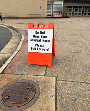 outdoor sign that says do not drop your student here. please pull forward.