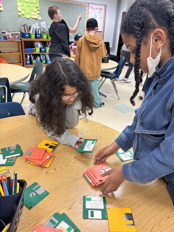 3rd graders observing floppy discs
