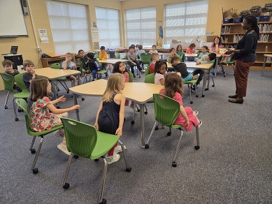 Students sit at our new library tables purchased with help from the PTA.