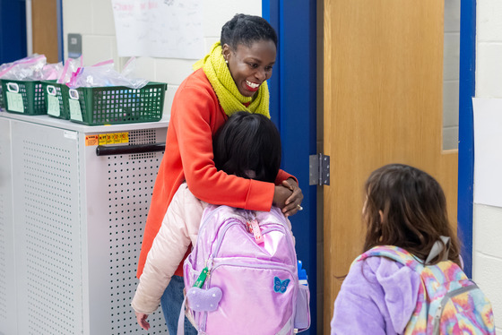 teacher hugs a student