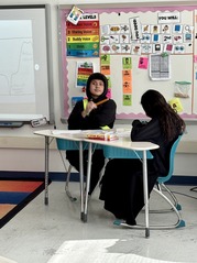 Student looking at the camera while creating their diagram. 