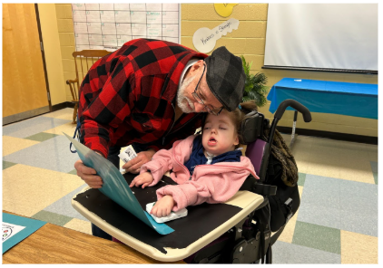 Student and parent looking at her art