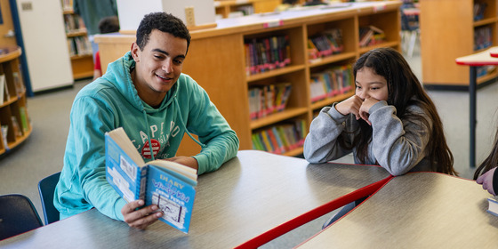 students reading a book together