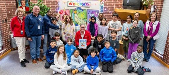 Dr. Reid reading a book to students