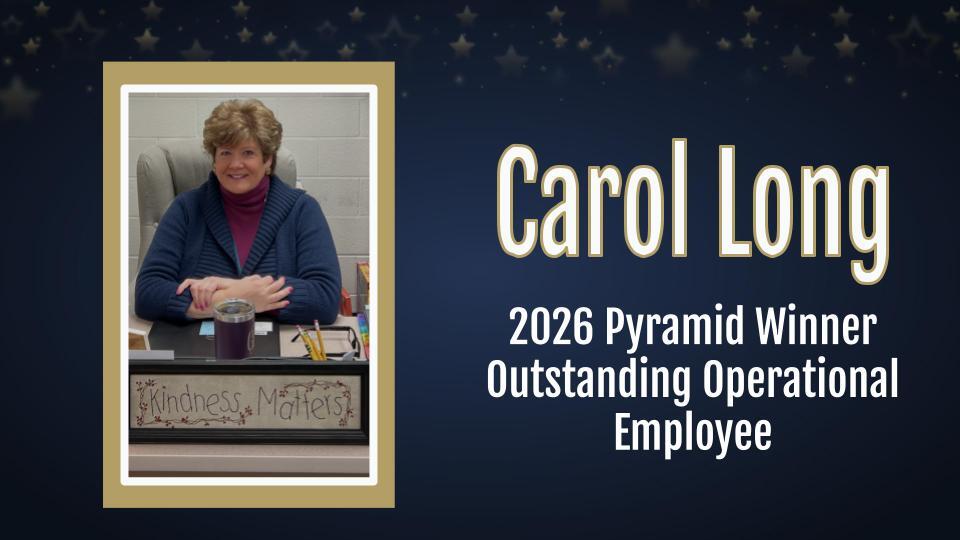 picture of staff member sitting at a desk