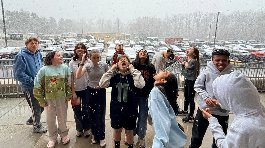 Students catching snowflakes on their tongues